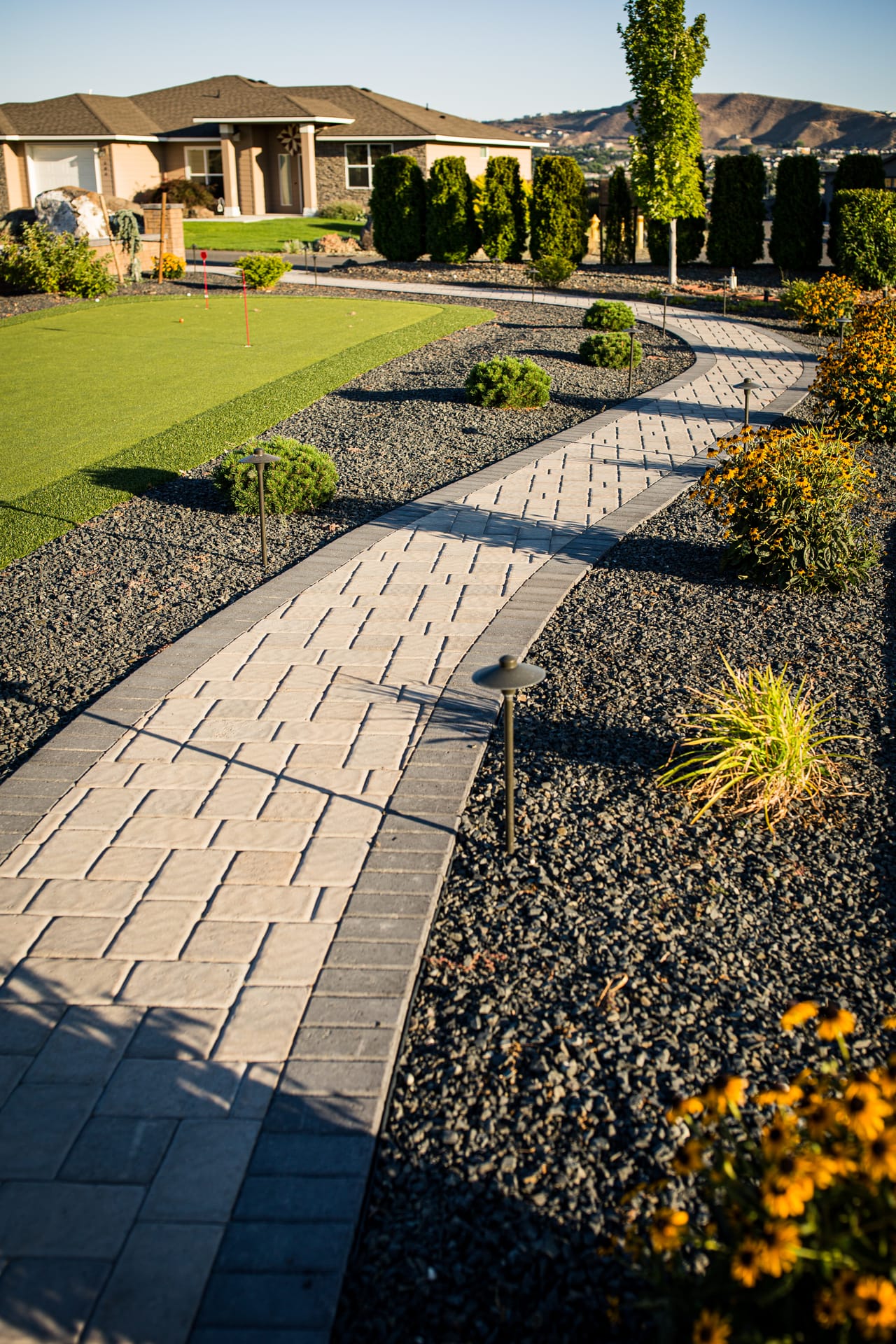 Completed outdoor living space with patio, planting, and lawn at the Dobson home