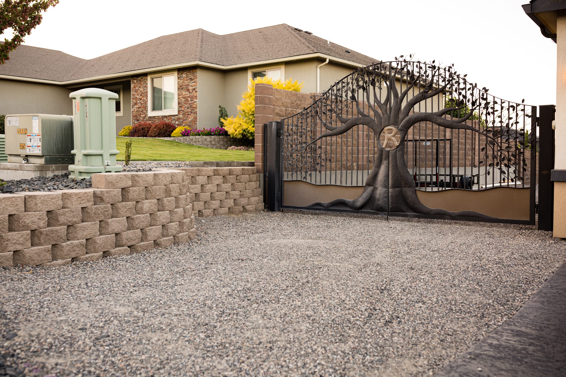 Wide view of a completed paver patio and landscaped backyard